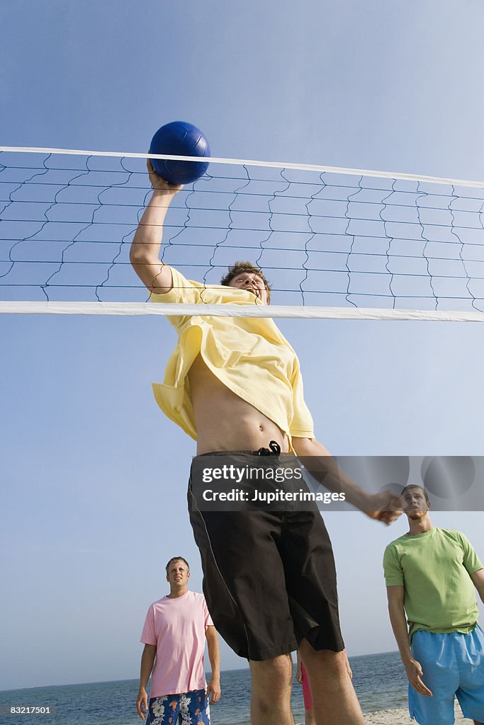 Man spiking volleyball