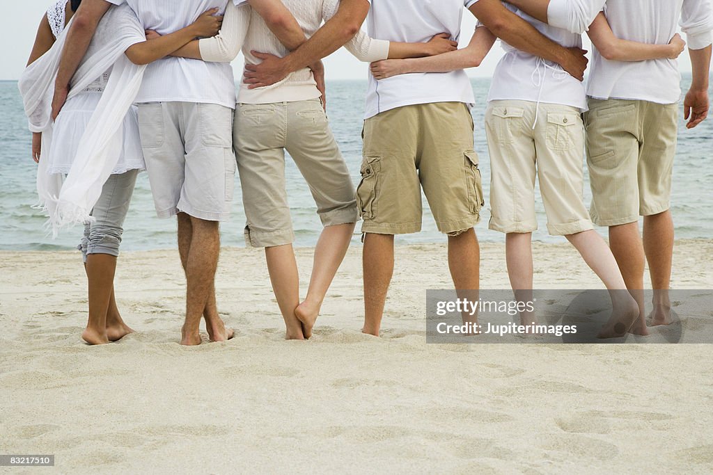 Friends embracing on beach