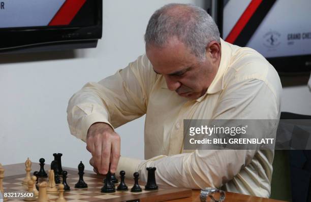 Grandmaster chess player Garry Kasparov makes a move in a match against grandmaster Levon Aronian during day two of the Grand Chess Tour at the Chess...