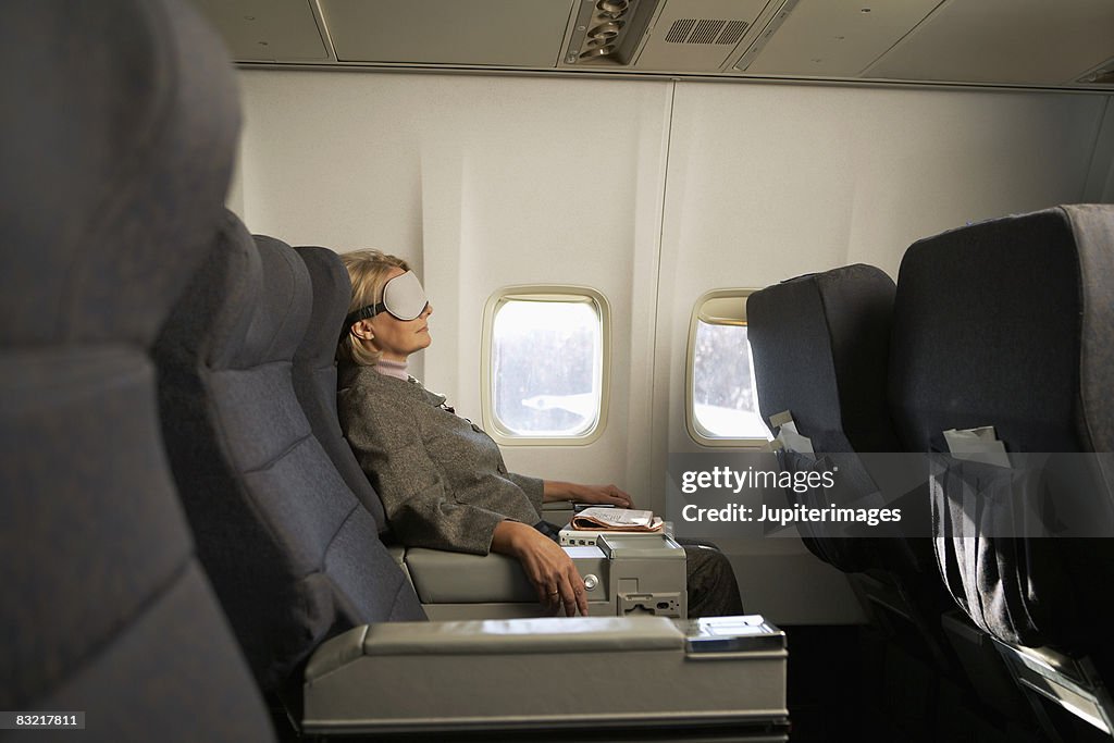 Businesswoman relaxing on airplane