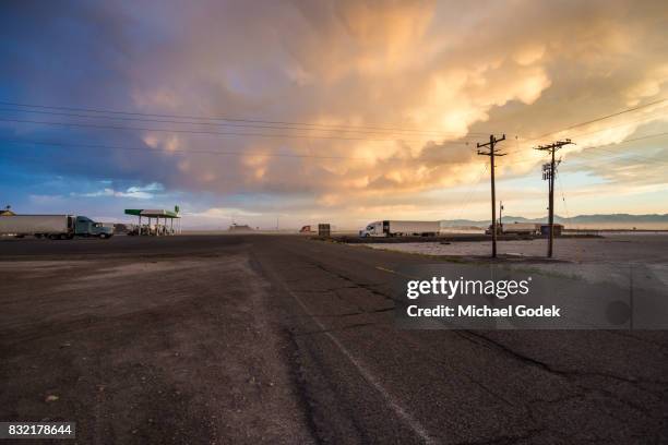 remote truck stop in utah salt flats with storm rolling in at twilight - wendover stock pictures, royalty-free photos & images