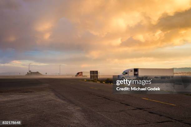 remote truck stop in utah salt flats with storm rolling in at twilight - wendover stock pictures, royalty-free photos & images