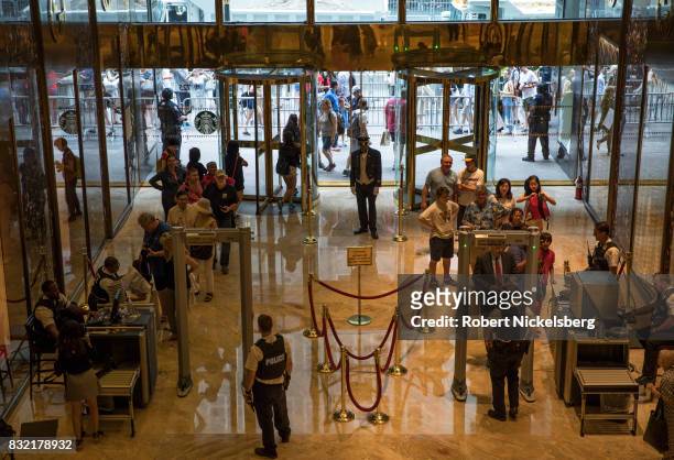 Tourists and shoppers clear Secret Service security before entering Trump Tower August 14, 2017 in New York City. Security throughout the area is...