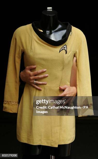 Christie's South Kensington employee Zoe Schoon, with a mustard-coloured Starfleet mini-dress uniform which is expected to fetch $3,000-5,000 in an...