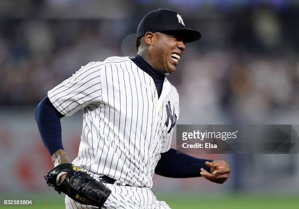 Aroldis Chapman of the New York Yankees winces in pain as he make the final out at first base in the ninth inning against the New York Mets during...