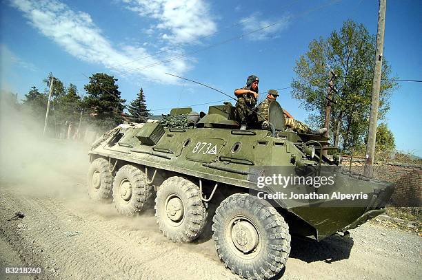Russian APC moves across the capital city on August 15, 2008 in Tskhinvali, South Ossetia. Hundreds of armored vehicles and tanks are operating...
