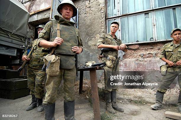 Russian troops guard the entrance of a storage hangar where small weapons are stored on August 16, 2008 in the South Ossetian capital city...