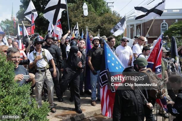 Hundreds of white nationalists, neo-Nazis, KKK and members of the "alt-right" hurl water bottles back and forth against counter demonstrators on the...