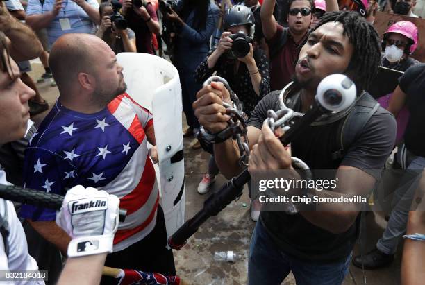 White nationalists, neo-Nazis and members of the "alt-right" exchange insluts with counter-protesters as they attempt to guard the entrance to...