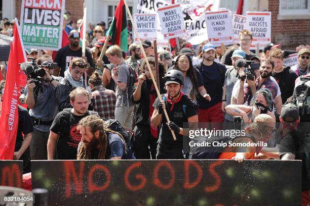 Counter protesters, some called the "antifa," face down hundreds of white nationalists, neo-Nazis, KKK and members of the "alt-right" outside...