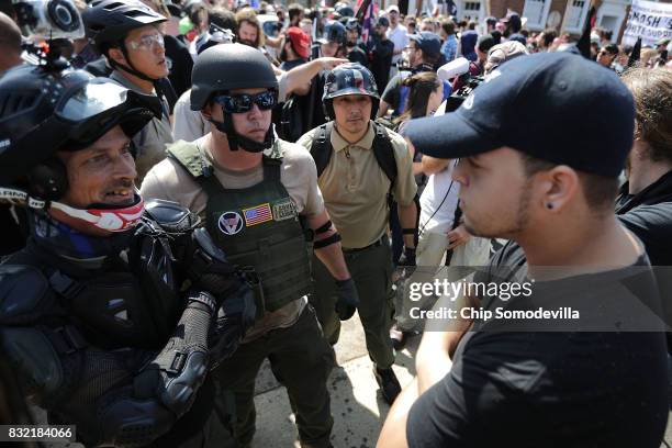 White nationalists, neo-Nazis and members of the "alt-right" exchange insults with counter-protesters as they enter Emancipation Park during the...