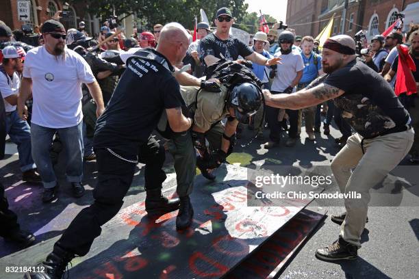 White nationalists, neo-Nazis, the KKK and members of the "alt-right" attack each other as a counter protester intervenes during the melee outside...