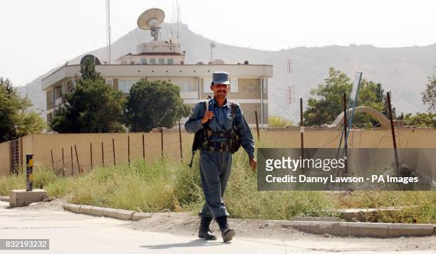 Guard walks in front of the British Embassy in Kabul, Afghanistan.