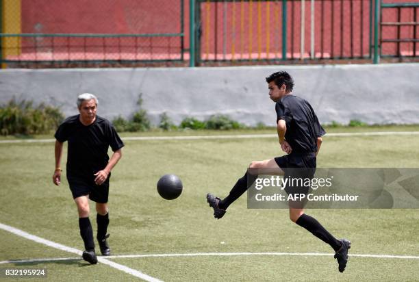 Men play during a match -in which both teams have black uniforms- as part of a performance called "Todos Contra Todos" of Chilean artist Camilo...