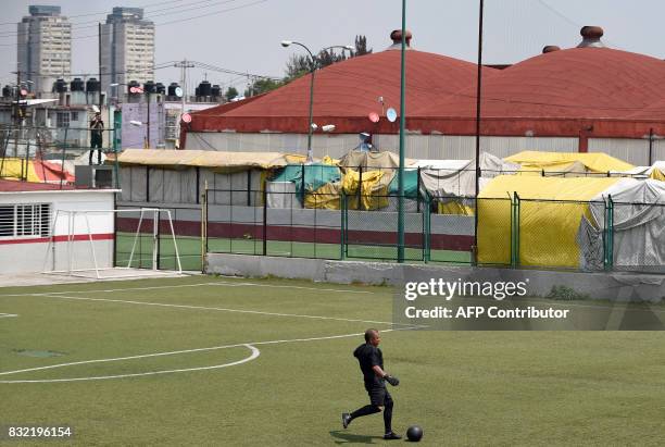 Man plays during a match -in which both teams have black uniforms- as part of a performance called "Todos Contra Todos" of Chilean artist Camilo...