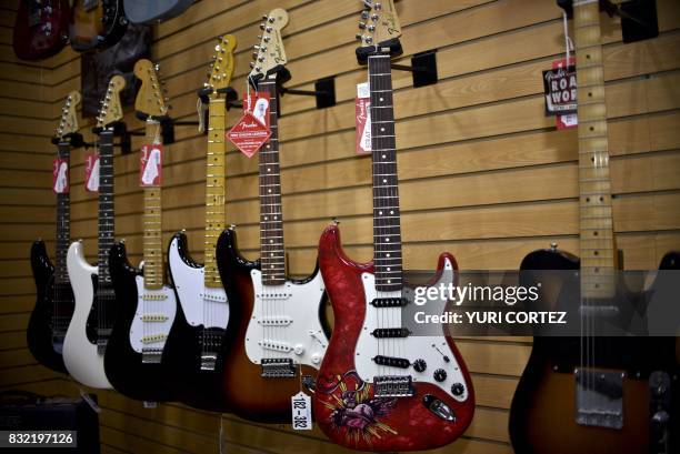 Different models of guitars made by US manufacturer Fender are displayed at the Custom Shop of Holocausto Audio Iluminacion Profesional distributor...