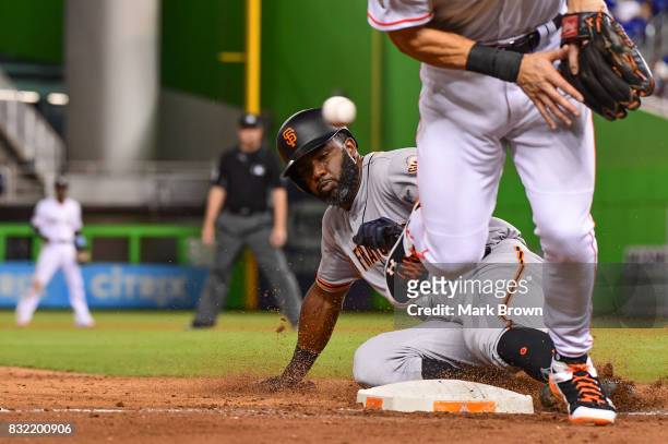 Carlos Moncrief of the San Francisco Giants steals third in the seventh inning during the game between the Miami Marlins and the San Francisco Giants...