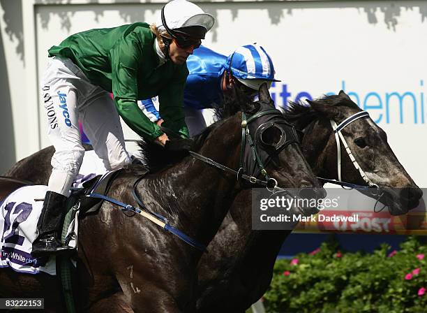 Jockey Chris Symons riding Bonded narrowly defeates Guild ridden by Luke Nolen to win Race 2 the Terry White Chmists Classic during the Caulfield...