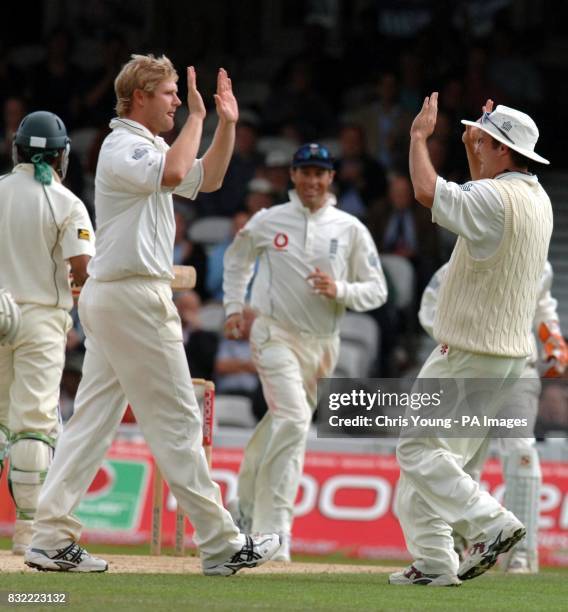 Matthew Hoggard, is congratulated by England captain Andrew Strauss following the wicket of Mohammad Hafeez for 95. Bowled by Matthew Hoggard and...