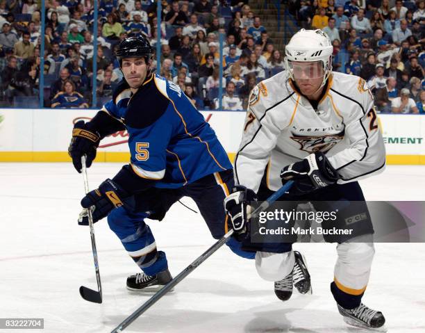 Patric Hornqvist of the Nashville Predators battles for the puck with Barret Jackman of the St. Louis Blues on October 10, 2008 at Scottrade Center...