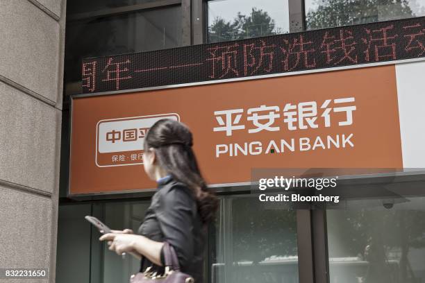 Pedestrian walks past a Ping An Bank Co. Branch, a unit of Ping An Insurance Group Co., in Shanghai, China, on Wednesday, Aug. 13, 2017. Ping An...