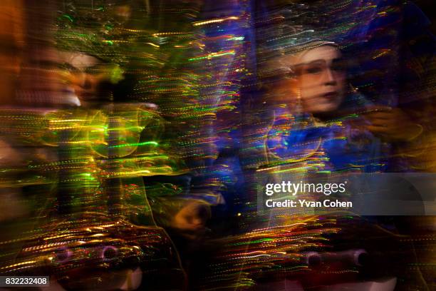 Motion blur image of a Chinese Opera performer onstage during a performance in the Chinatown area of Bangkok.