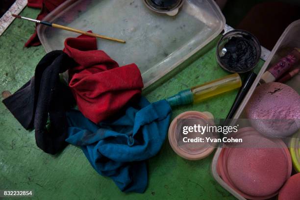 Make up, rags and brushes on the dressing table of a Chinese Opera performer in the Chinatown area of Bangkok.