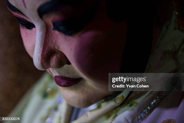 Close up of a heavily made up Chinese Opera performer taken back stage during a performance in the Chinatown area of Bangkok.