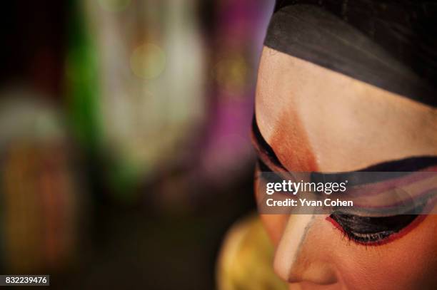 Close up of a heavily made up performer in the a Chinese opera in the Chinatown area of Bangkok.