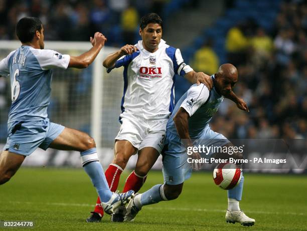 Trevor Sinclair, Manchester City and Dejan Stefanovic, Portsmouth battle for the ball