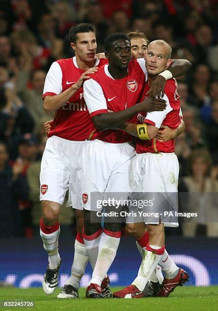 Arsenal's Robin van Persie , Kolo Toure congratulate captain Freddie Lungberg on his goal against Dinamo Zagreb during the Champions League third...