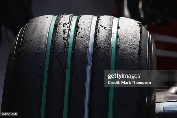 Detail view of Bridgestones specially prepared green-grooved tyre in support for the FIA's Make Cars Green campaign are seen in the paddock following...