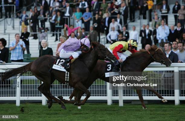 Jockey Dane O'Neill riding Amour Propre head of Frankie Dettori riding Waffle wins The Willmott Dixon Cornwallis Stakes at Ascot Racecourse on...