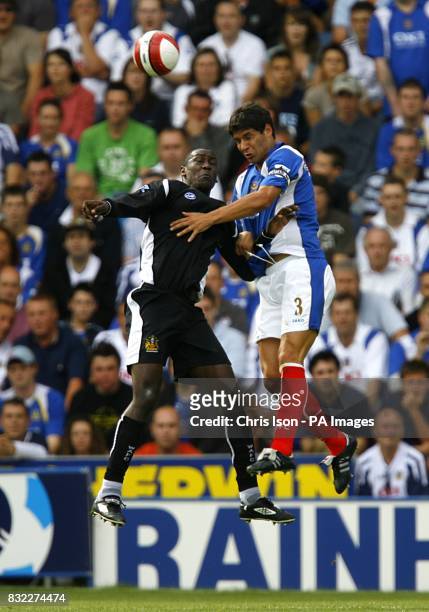 Wigan Athletic's Emile Heskey and Portsmouth's Dejan Stefanovic battle for the ball