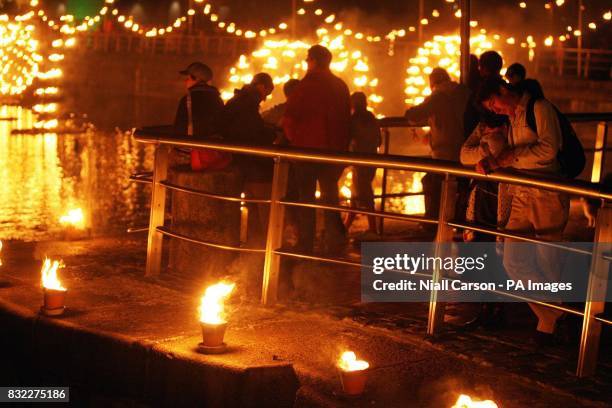 People watch a fire installation by French group Compagnie Carabosse at George's Dock in Dublin.