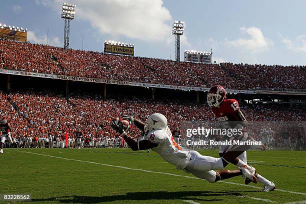 Wide receiver Quan Cosby of the Texas Longhorns makes a pass reception against Dominique Franks of the Oklahoma Sooners during the Red River Rivalry...