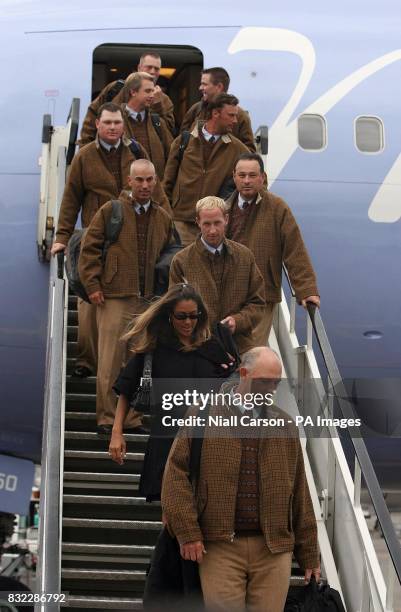 Ryder Cup golf captain Tom Lehman and his wife Melissa lead the team off their plane at Dublin Airport.