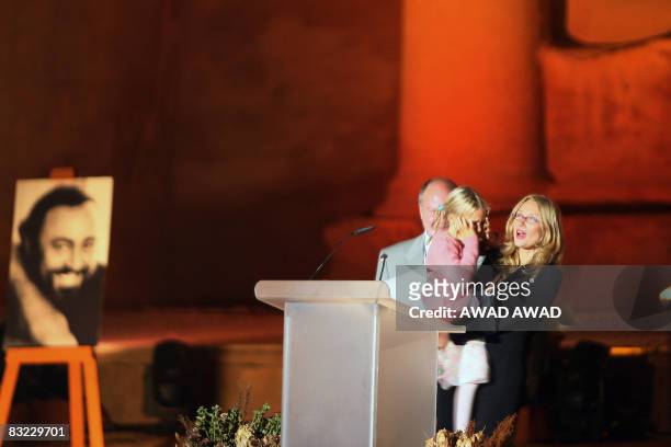 Nicoletta Mantovani Pavarotti, the wife of the late Italian Maestro Luciano Pavarotti, holds their doughter Alice next to a large portrait of...