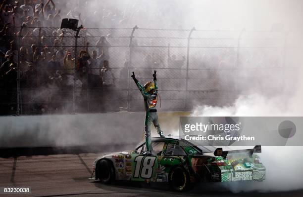 Kyle Busch, driver of the M&M's Indiana Jones Toyota, celebrates after winning the NASCAR Sprint Cup Series Dodge Challenger 500 on May 10, 2008 at...