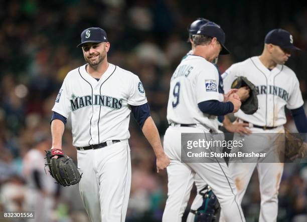 Relief pitcher Marc Rzepczynski of the Seattle Mariners smiles as he leaves after facing one batter during the eighth inning of a game against the...