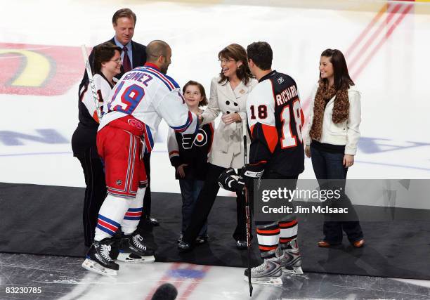 Republican vice-presidential candidate Alaska Gov. Sarah Palin shakes hands with Alaskan native Scott Gomez of the New York Rangers before dropping...