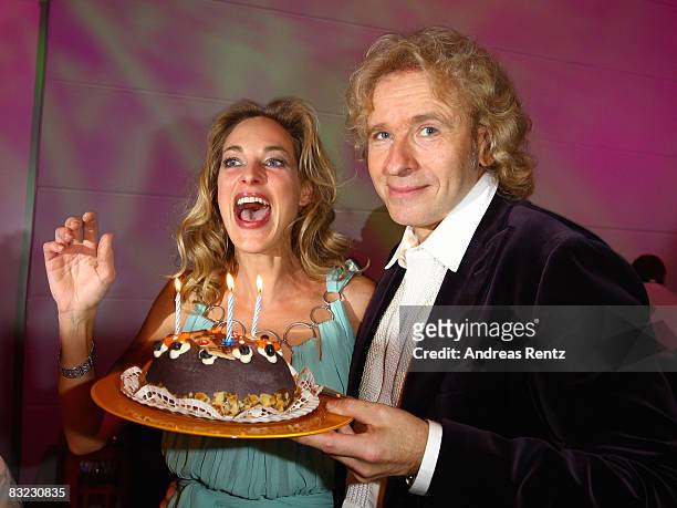 Actress Sophie von Kessel smiles as Thomas Gottschalk holds up a birthday cake to her 30th birthday during the after show party to the German TV...