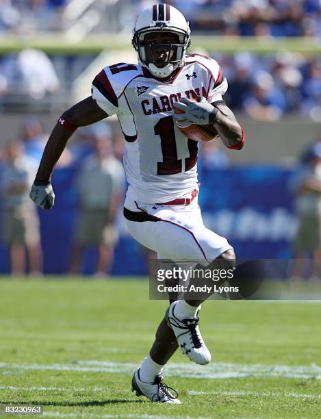 Kenny McKinley of the South Carolina Gamecocks runs with the ball against the Kentucky Widcats during the game at Commonwealth Stadium on October 11,...