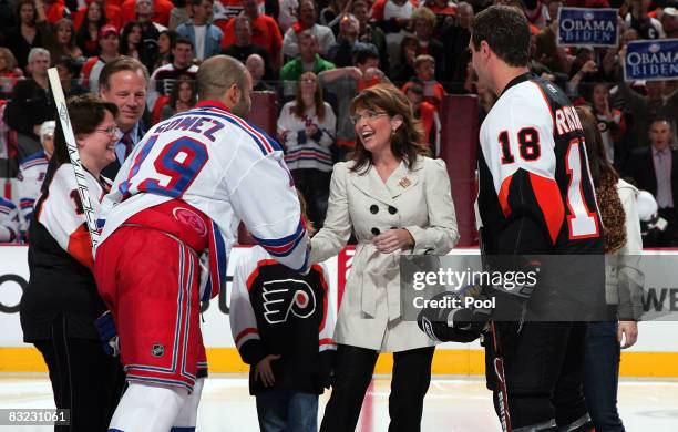 Republican vice-presidential candidate Alaska Gov. Sarah Palin shakes hands with Alaskan native Scott Gomez of the New York Rangers before dropping...