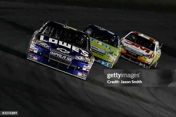 Jimmie Johnson, driver of the Lowe's Chevrolet, leads Carl Edwards, driver of the Aflac Ford, and Greg Biffle, driver of the 3M Ford, during the...