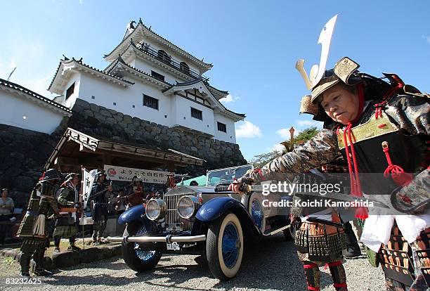 Classic car owners drive their vintage automobiles past the crowds during the 2008 La Festa Mille Miglia classic car rally at the Shiroishi Castle on...