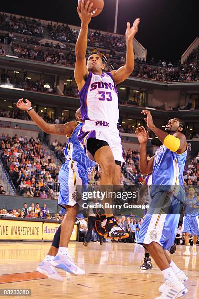 Grant Hill of the Phoenix Suns shoots against Nen� #31 of the Denver Nuggets in an NBA game played on October 11 at Indian Wells Tennis Garden in...