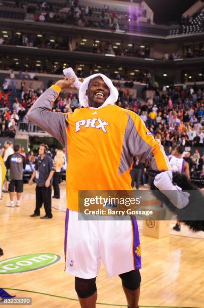 Shaquille O'Neal of the Phoenix Suns throws tshirts to fans following the NBA game against the Denver Nuggets played on October 11 at Indian Wells...
