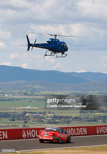 Craig Lowndes and Jamie Whincup of Team Vodafone are tracked by a helicopter during the Bathurst 1000, which is round 10 of the V8 Supercars...