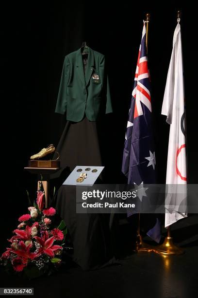 Olympic medals and memorabilia are seen on disply on the stage during the funeral service for Betty Cuthbert at Mandurah Performing Arts Centre on...